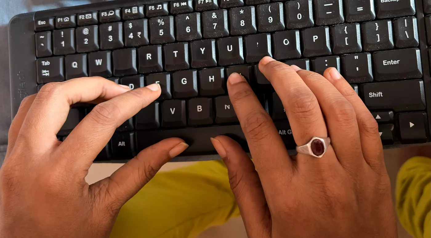 Hands demonstrating efficient finger movement on a keyboard while maintaining proper home-row positioning for touch typing.
