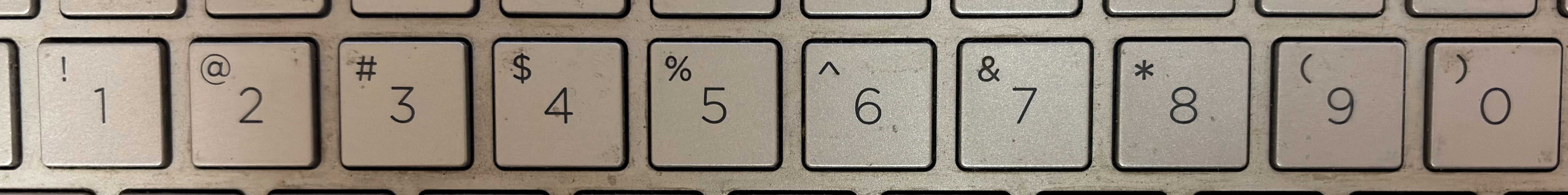Keyboard number row with punctuation keys