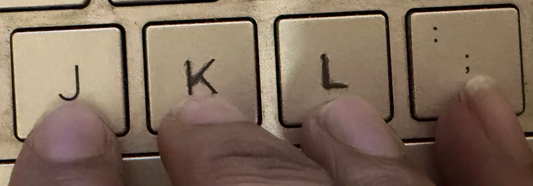 Right hand finger placement on the home row showing the correct position for J, K, L, and semicolon keys in touch typing.